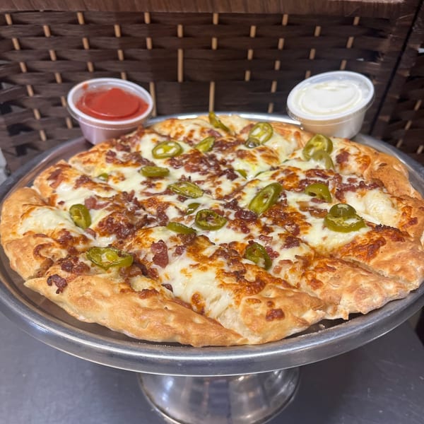 Cicero's Pizza with melted cheese, bacon, and jalapeños, served with two dipping sauces.